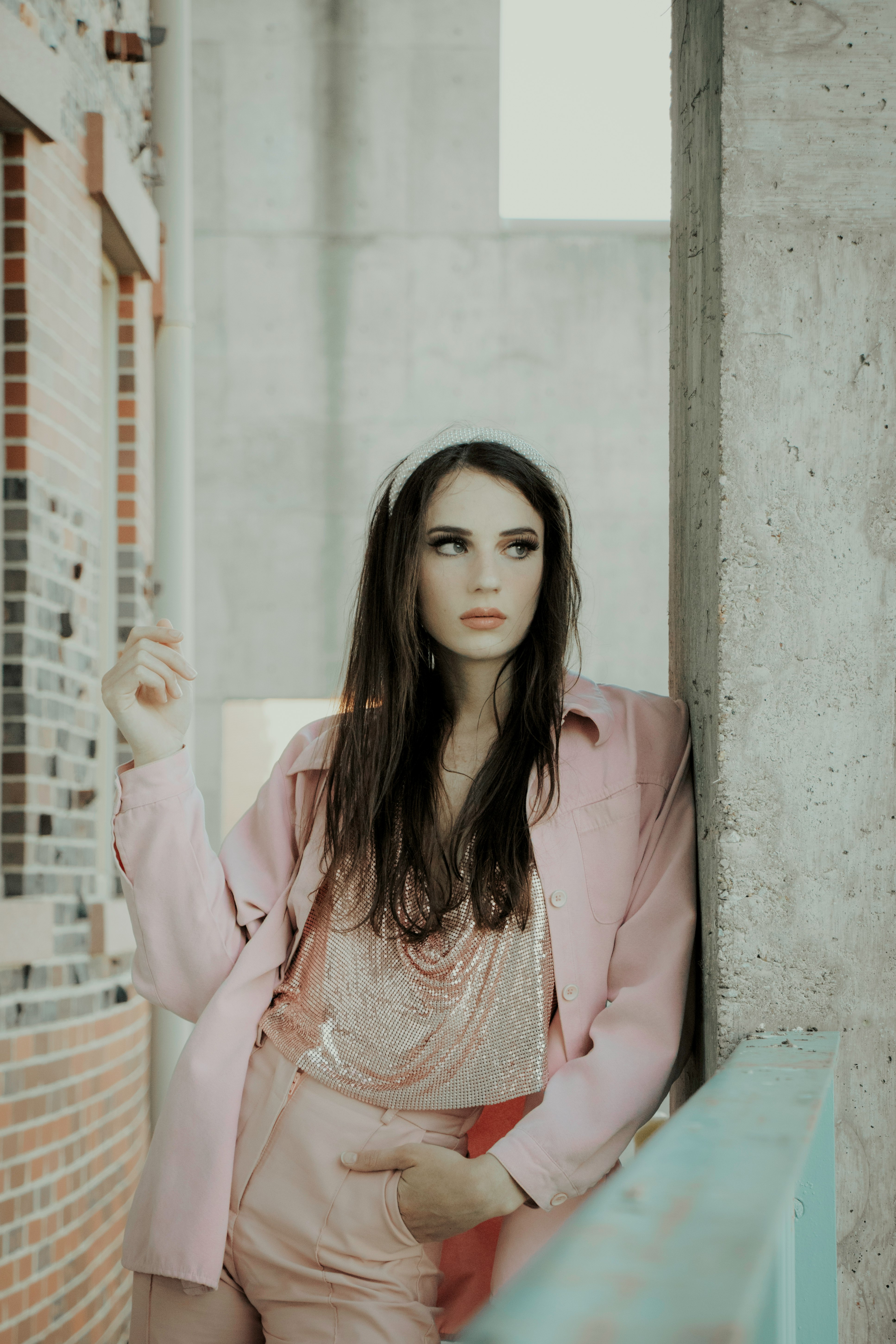 woman in pink blazer sitting on bench